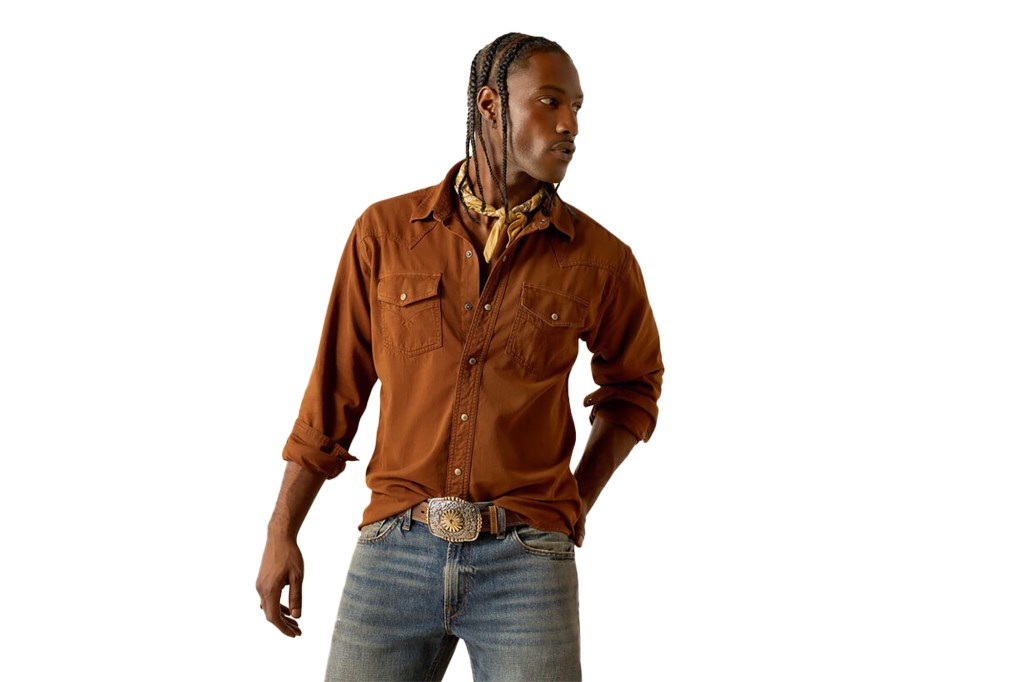 A man wearing a brown shirt and jeans