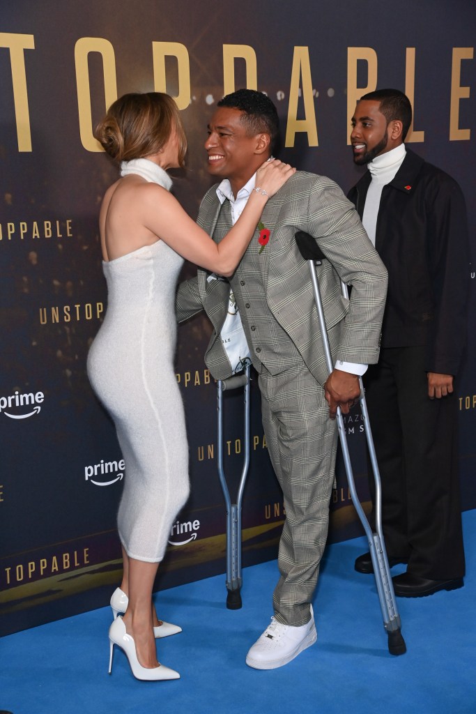 Anthony Robles, Jennifer Lopez, and Jharrel Jerome at the UK Special Screening of 'Unstoppable' at Cineworld Leicester Square, London, with Robles on crutches and Lopez hugging him.