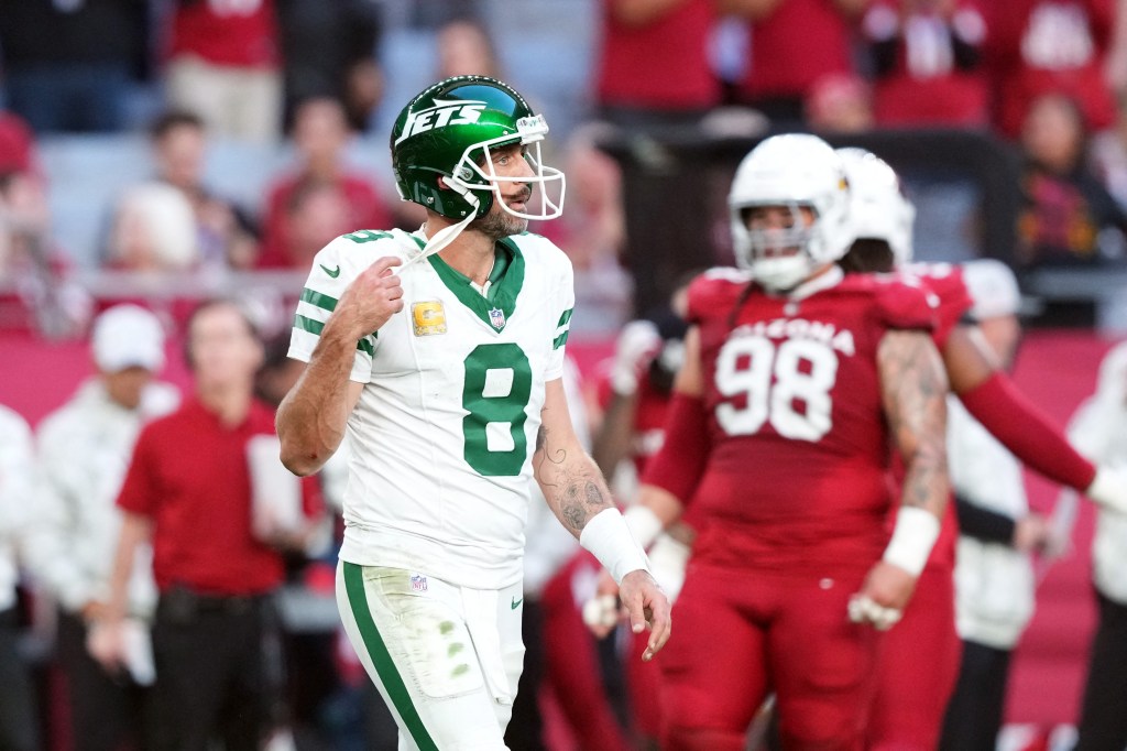 New York Jets quarterback Aaron Rodgers (8) walks off the field against the Arizona Cardinals during the second half at State Farm Stadium. 