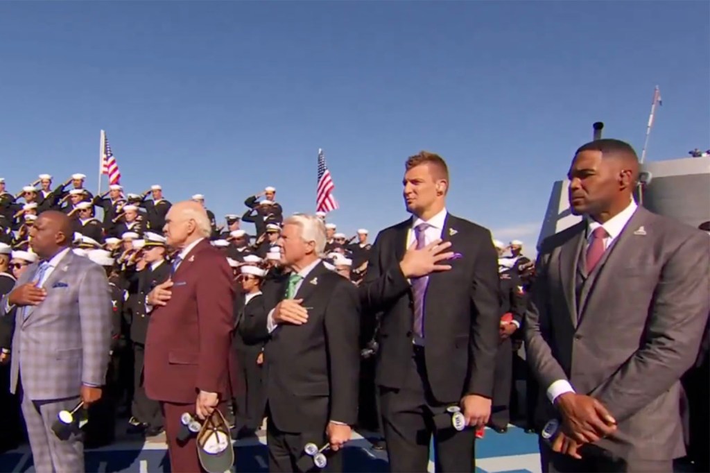 Michael Strahan faced backlash for standing with his arms down during the national anthem on "NFL on Fox" at the Naval Base in San Diego on Nov. 10, 2024. 