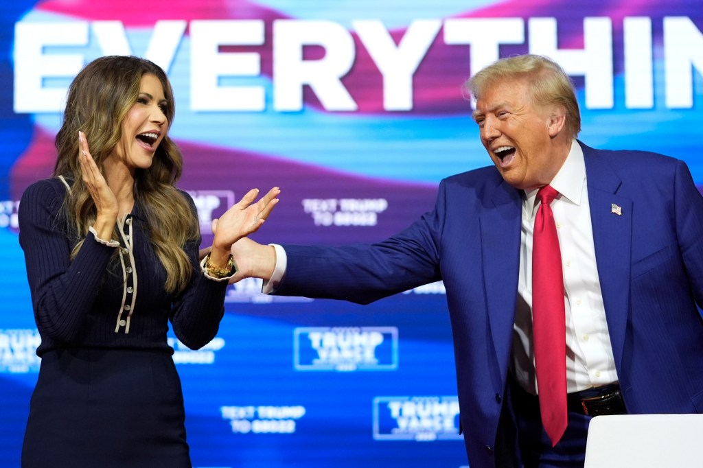 President Donald Trump reacts with South Dakota Gov. Kristi Noem after dancing to the song "Y.M.C.A." at a campaign town hall at the Greater Philadelphia Expo Center & Fairgrounds, Monday, Oct. 14, 2024, in Oaks, Pa.