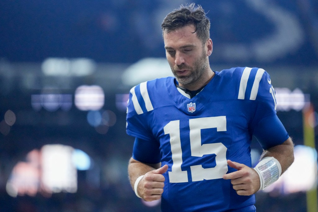 Indianapolis Colts quarterback Joe Flacco, wearing a blue jersey, leaving the field at Lucas Oil Stadium after a 30-20 loss to the Buffalo Bills on November 10, 2024