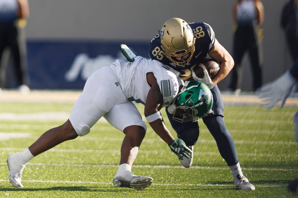 An Eastern Michigan player makes a tackle against Akron earlier this year.