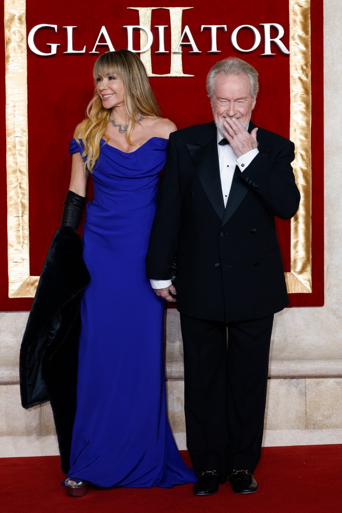 Giannina Facio in a blue dress and Ridley Scott in a tuxedo posing for photographers at the 'Gladiator II' premiere in London, 2024