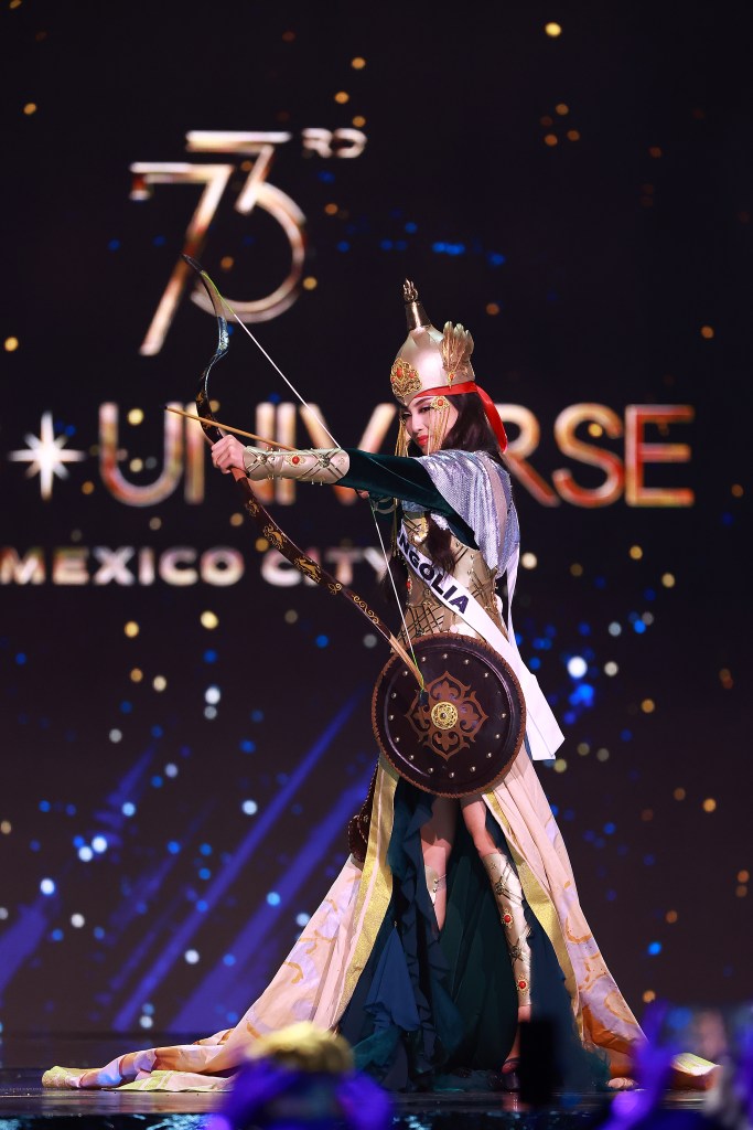 Miss Mongolia Nominzul Zandangiin in a garment, holding a bow and arrow, during the 73rd Miss Universe Preliminary Competition.