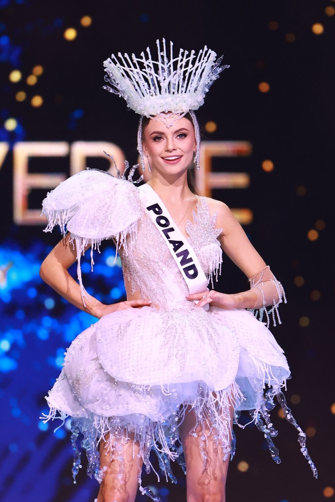 Miss Poland, Kasandra Zawal, wearing a white dress and sash, participating in the 73rd Miss Universe preliminary competition in Mexico City