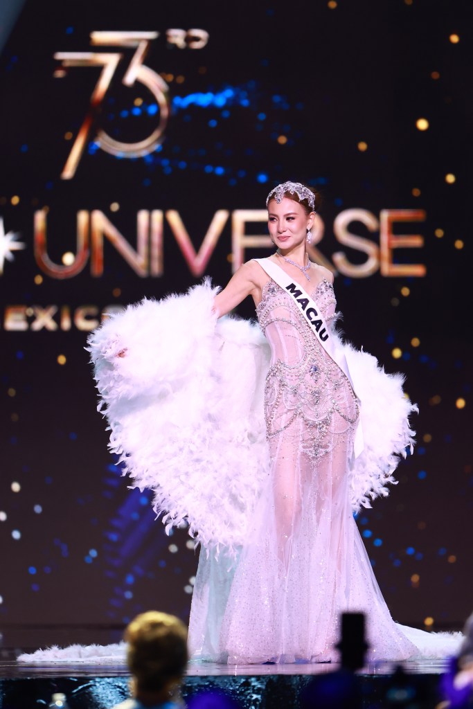 Miss Macau Cassandra Chiu participating in the 73rd Miss Universe Preliminary Competition wearing a white dress with feathers