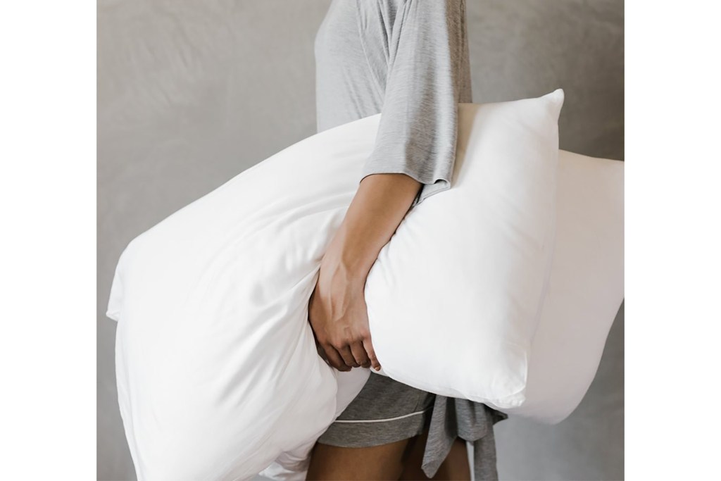 A person holding a pillow