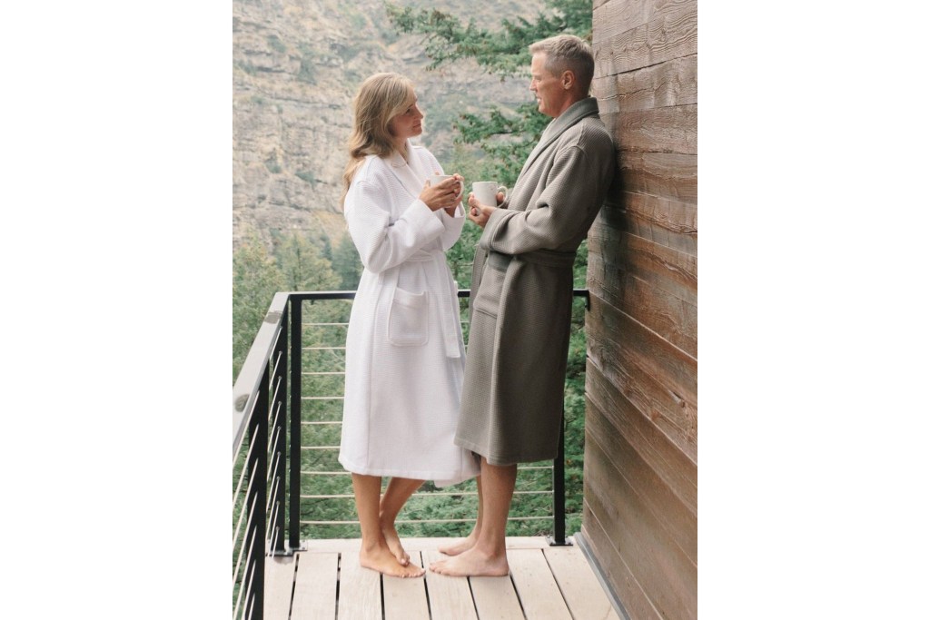 A man and woman standing on a balcony