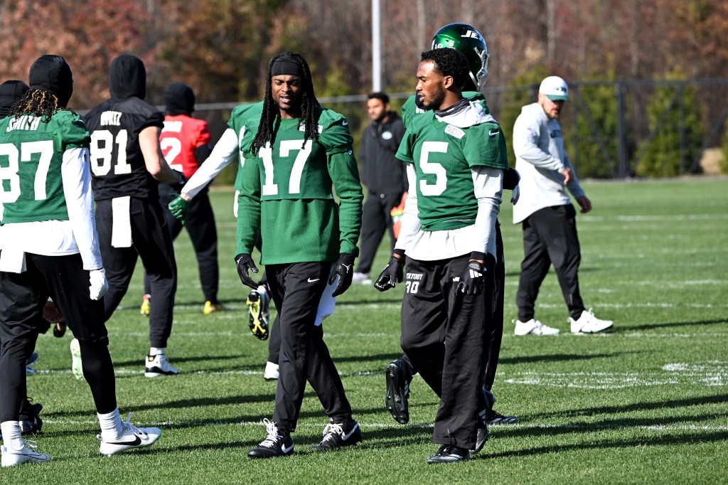 Davante Adams (17) and Garrett Wilson (5) talk at practice in Florham Park, NJ.