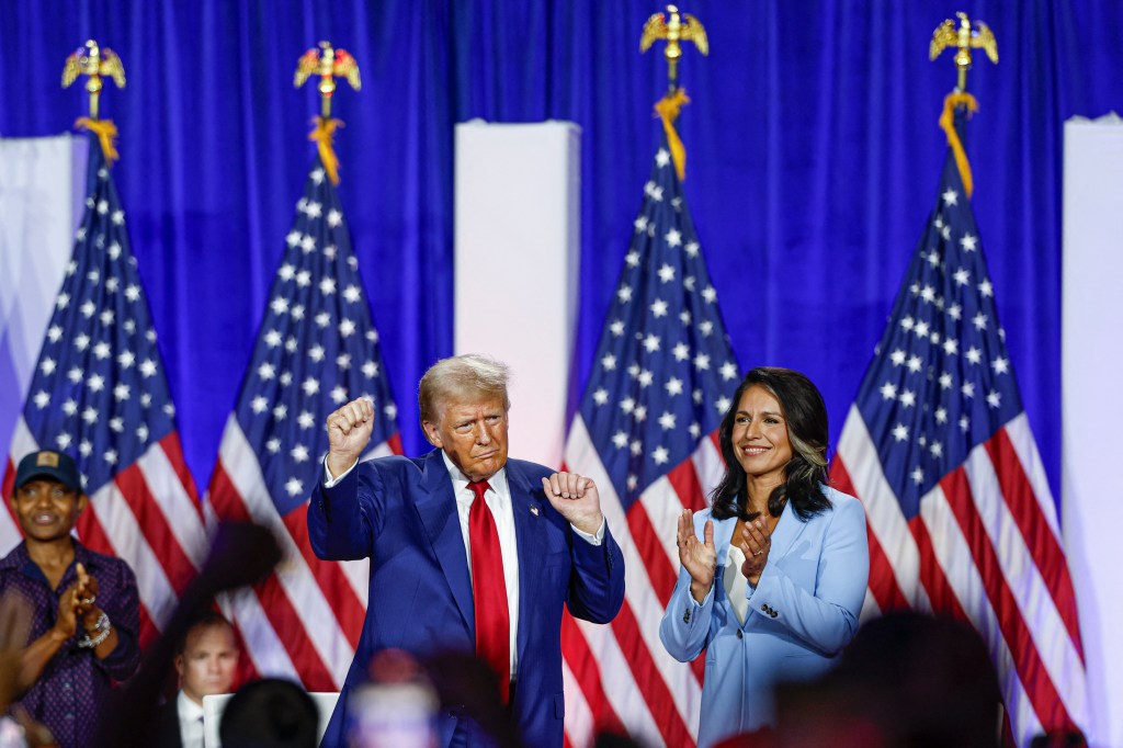 Former President and Republican presidential candidate Donald Trump and former US Representative Tulsi Gabbard react during a town hall meeting in La Crosse, Wisconsin, on August 29, 2024.