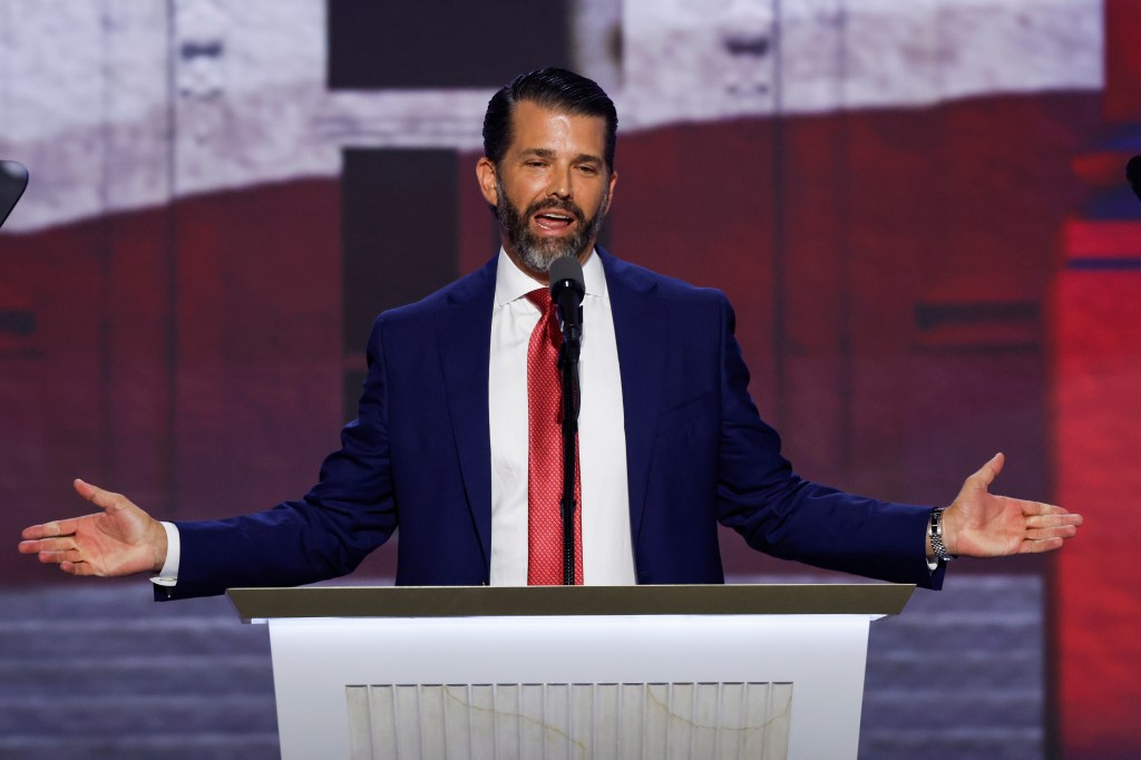 Donald Trump Jr. delivering a speech on stage at the 2024 Republican National Convention in Milwaukee, Wisconsin