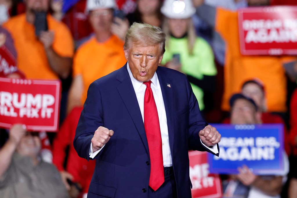 President-elect Donald Trump dances as he walks on stage during a campaign rally at Van Andel Arena in Grand Rapids, Michigan on November 5, 2024. 