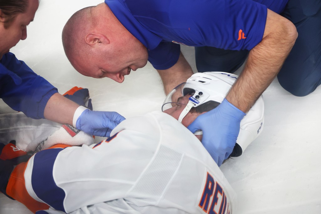 Islanders defenseman Mike Reilly is examined by a trainer after suffering a concussion against the Sabres on Nov. 1, 2024.