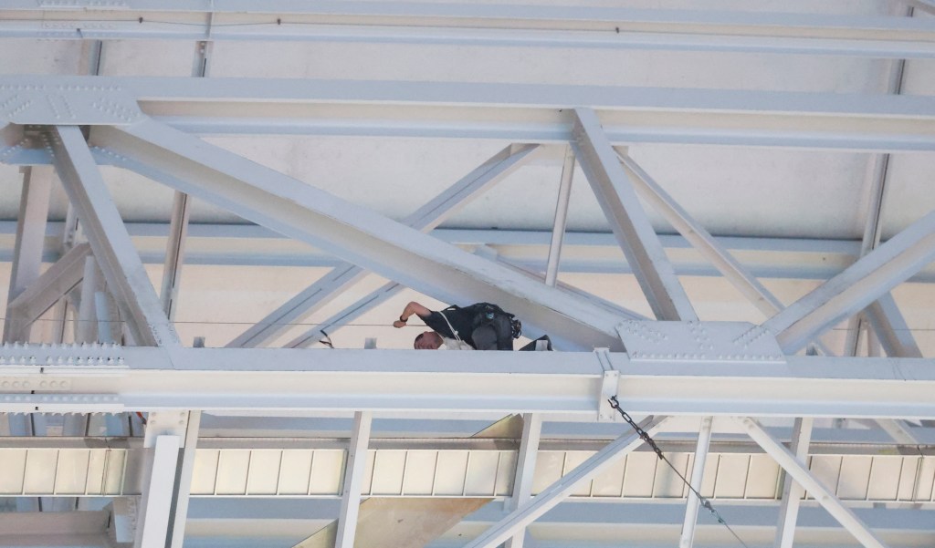 A worker secures the catwalk area of the stadium after debris fell onto the field before the game between the Dallas Cowboys and Houston Texans