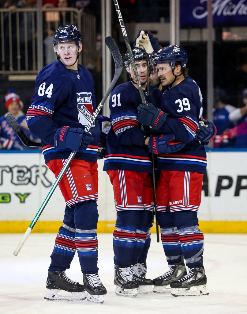 New York Rangers center Adam Edstrom (84) celebrates his goal with right wing Reilly Smith (91) and center Sam Carrick (39) during the third period against the New York Islanders at Madison Square Garden. 