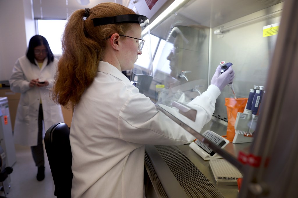 Microbiologist Anne Vandenburg-Carroll tests poultry samples collected from a farm located in a control area for the presence of bird flu at the Wisconsin Veterinary Diagnostic Laboratory at the University of Wisconsin-Madison on March 24, 2022. The Centers for Disease Control and Prevention has identified 46 human cases of bird flu since April.