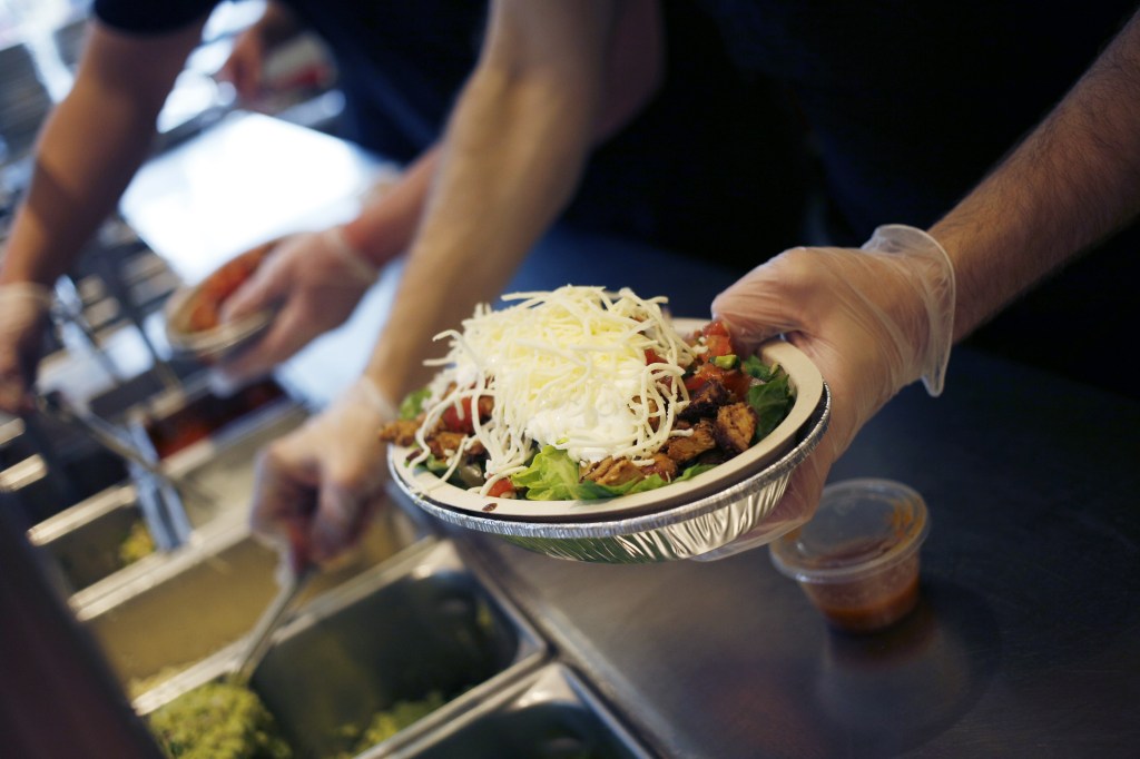 An employee prepares a burrito bowl at a Chipotle Mexican Grill Inc. restaurant in Louisville, Kentucky, U.S., on Saturday, Feb. 2, 2019. 