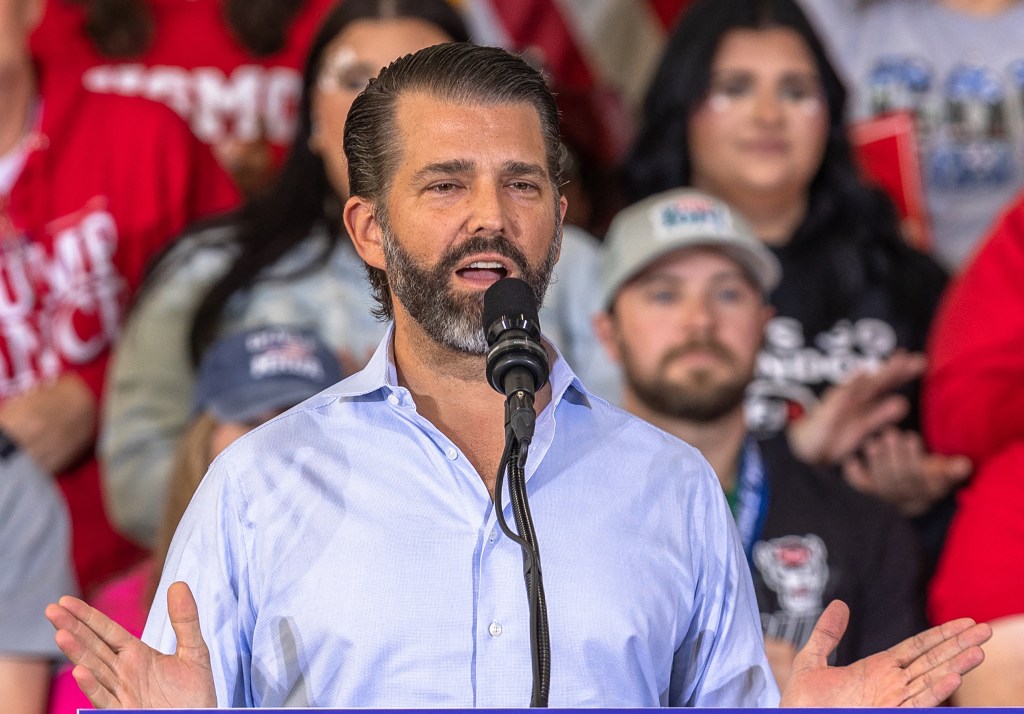 Donald Trump Jr. speaking into a microphone at a campaign rally in Sanford, North Carolina on November 3, 2024