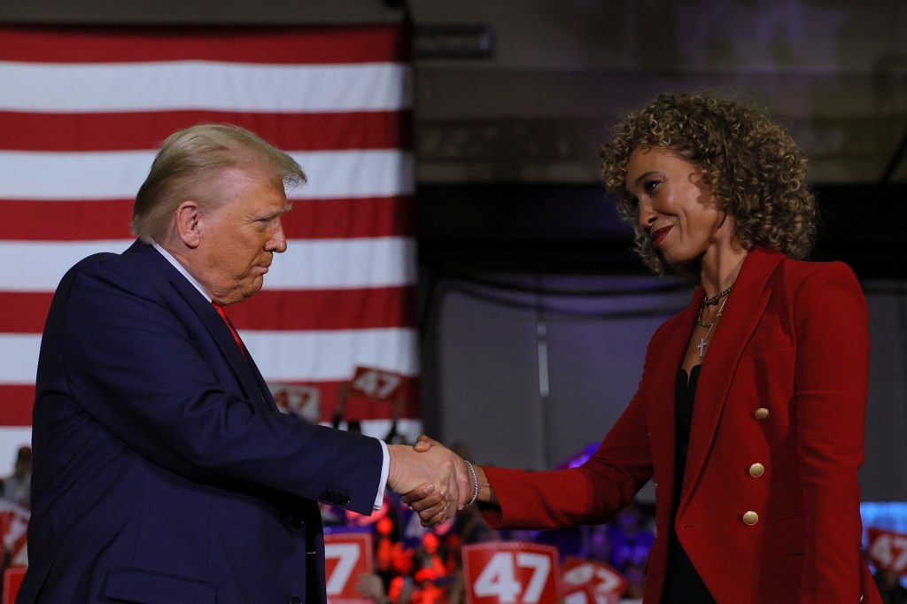 President-elect Donald Trump and Sage Steele shake hands at a campaign town hall meeting in Lancaster, Pennsylvania, U.S. October 20, 2024.