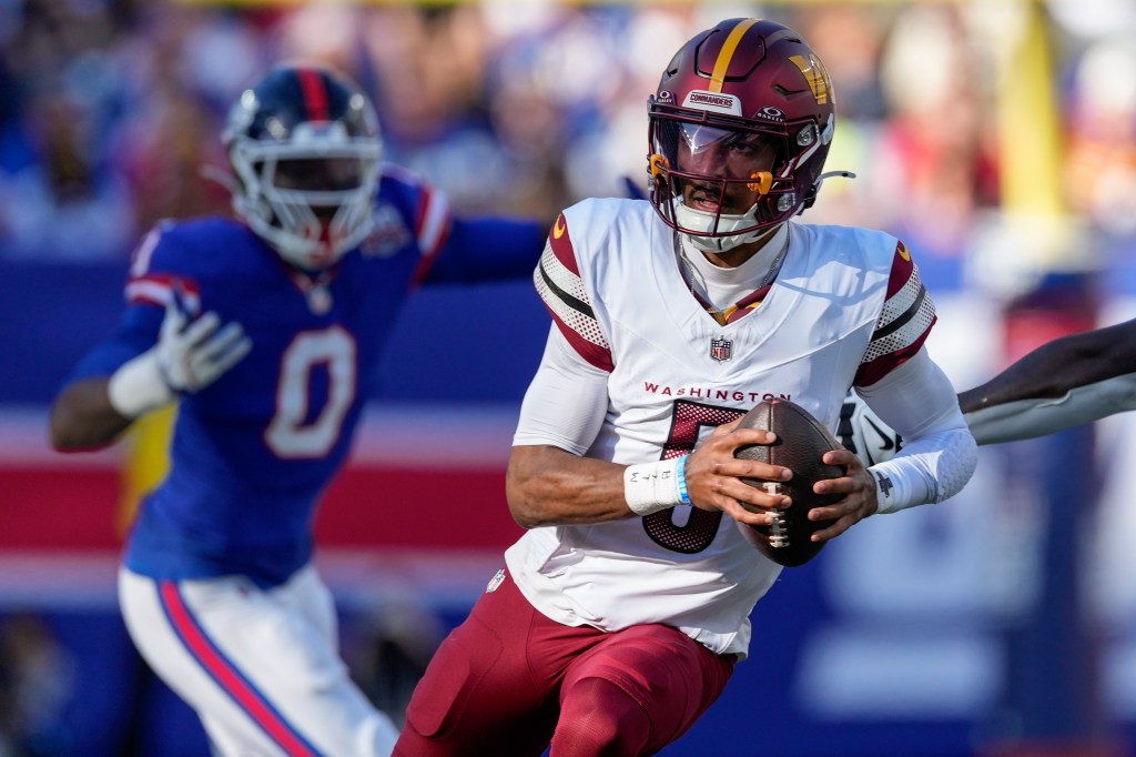 Jayden Daniels runs with the ball during the Commanders' win over the Giants on Nov. 3, 2024. 