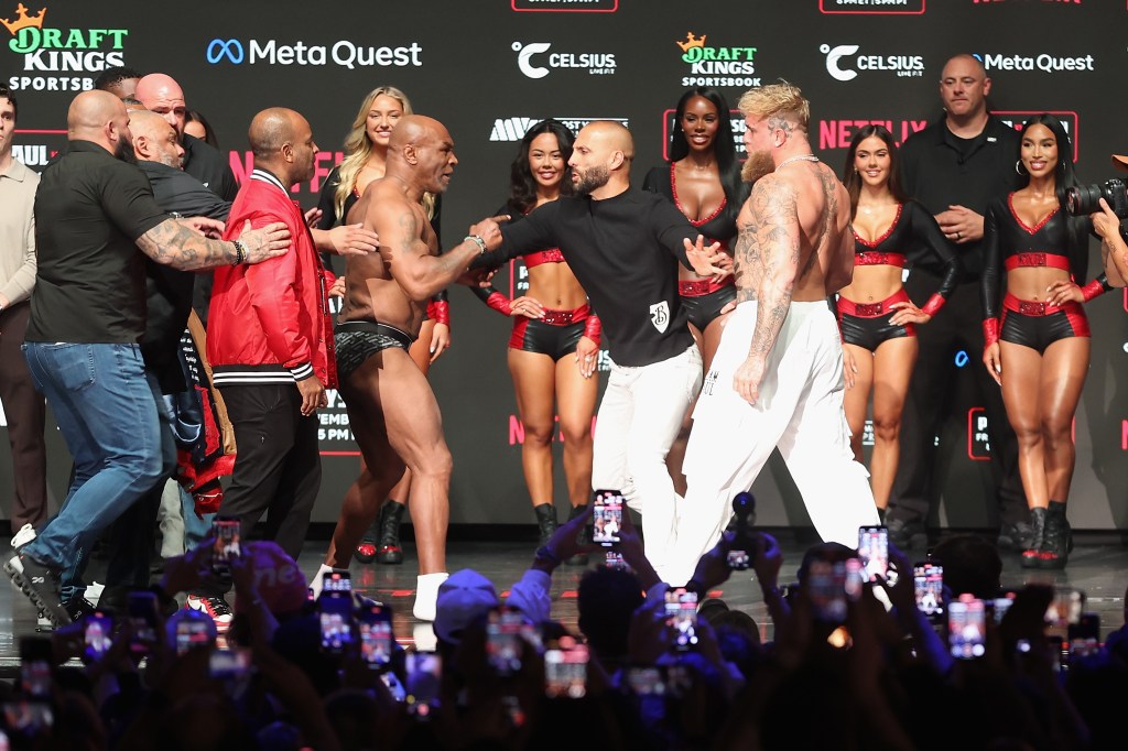 Mike Tyson and Jake Paul are separated as they face off during their ceremonial weigh-in at The Pavilion at Toyota Music Factory