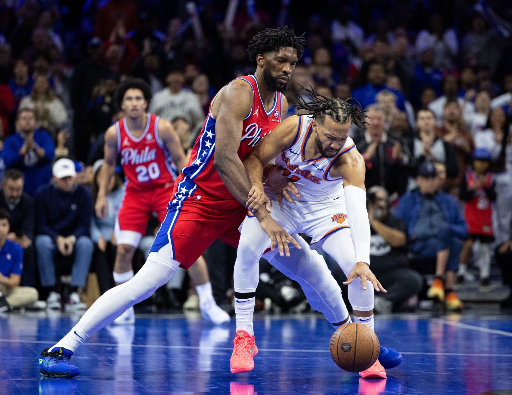 Philadelphia 76ers center Joel Embiid (21) defends against New York Knicks guard Jalen Brunson (11) during the third quarter at Wells Fargo Center.