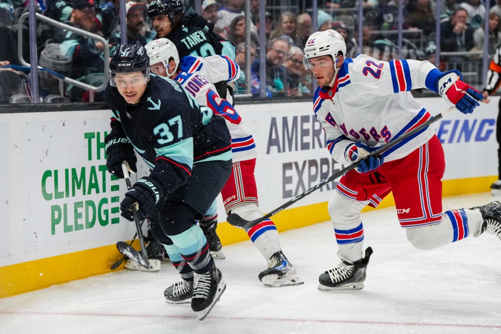  Yanni Gourde #37 of the Seattle Kraken skates as Jonny Brodzinski #22 of the New York Rangers pursues during the second period of a ga at Climate Pledge Arena on November 17, 2024 in Seattle, Washington.