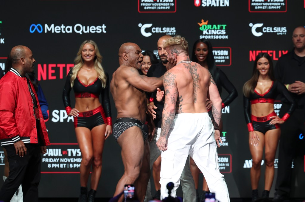 Mike Tyson (left) slaps Jake Paul (right) after weighing in at the Toyota Music Factory.