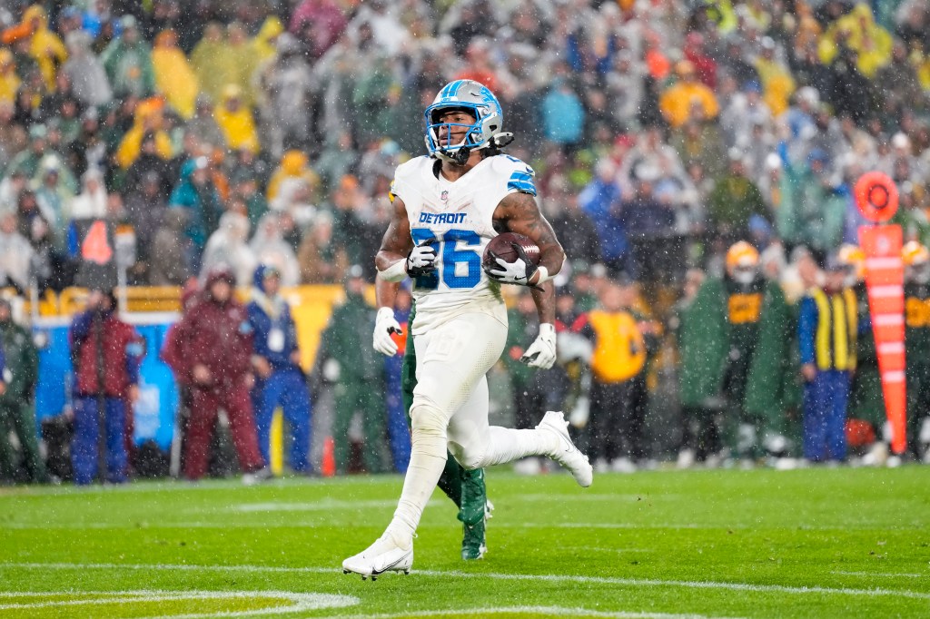 Detroit Lions running back Jahmyr Gibbs (26) rushes for a touchdown during the third quarter against the Green Bay Packers at Lambeau Field.