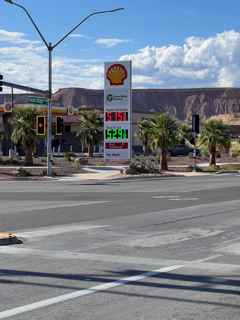 Mesquite, Nevada residents at a local gas station a year ago, paying a higher price for gas with cash compared to current lower prices in October 2024.