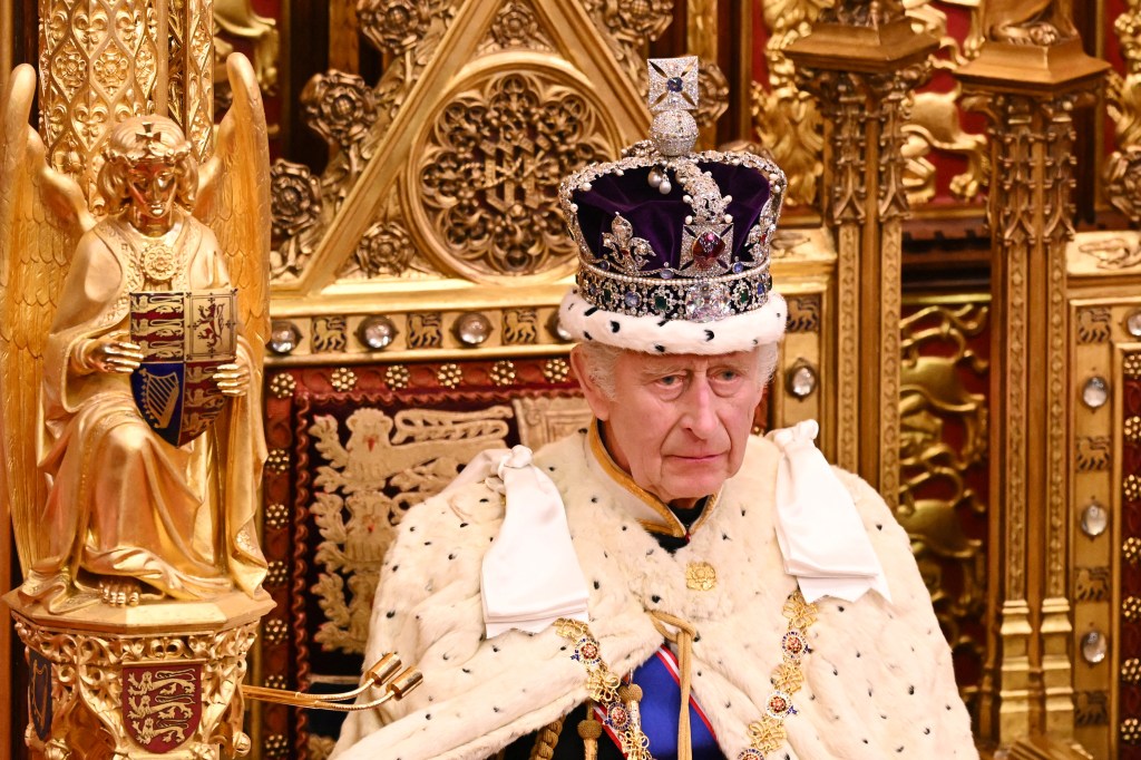 Britain's King Charles III, wearing the Imperial State Crown and the Robe of State, sits on The Sovereign's Throne in the House of Lords chamber, during the State Opening of Parliament, at the Houses of Parliament, in London, on November 7, 2023.