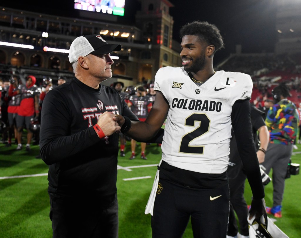 Texas Tech's head coach Joey McGuire, left, and Colorado's quarterback Shedeur Sanders (2) shake hands after the NCAA college football game,