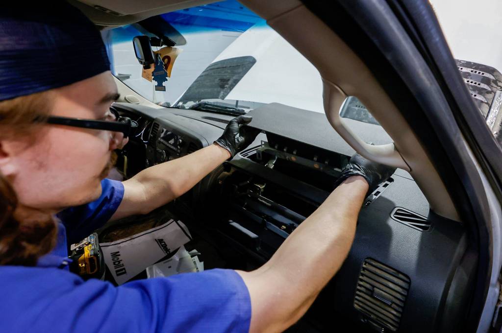 Bowman Chevrolet service technician Anthony Carbone, 22 of Rochester Hills, removes a recalled Takata front passenger airbag out of a Chevrolet Silverado in Clarkston, on Tuesday, June 25, 2024
