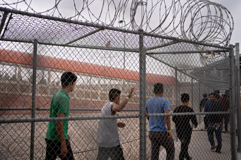 Migrants being deported back to Mexico under Title 8 walk through the CBP Paso del Norte Port of Entry in El Paso, Texas.