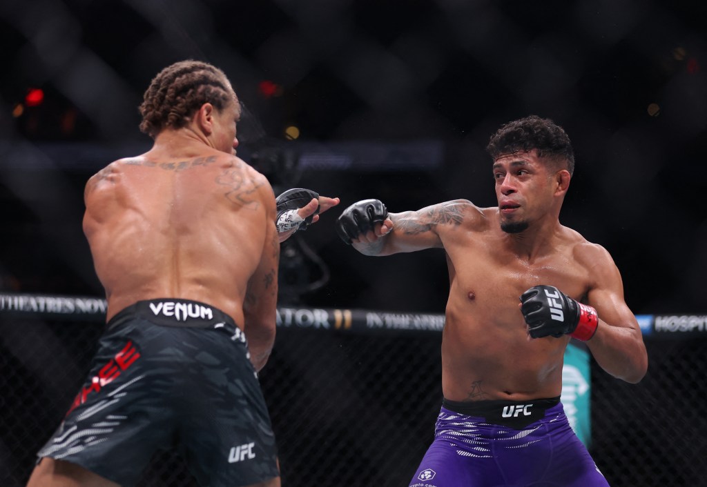 Jonathan Martinez (red gloves) fights Marcus Mcghee (blue gloves) in a bantamweight bout at UFC 309 at Madison Square Garden.