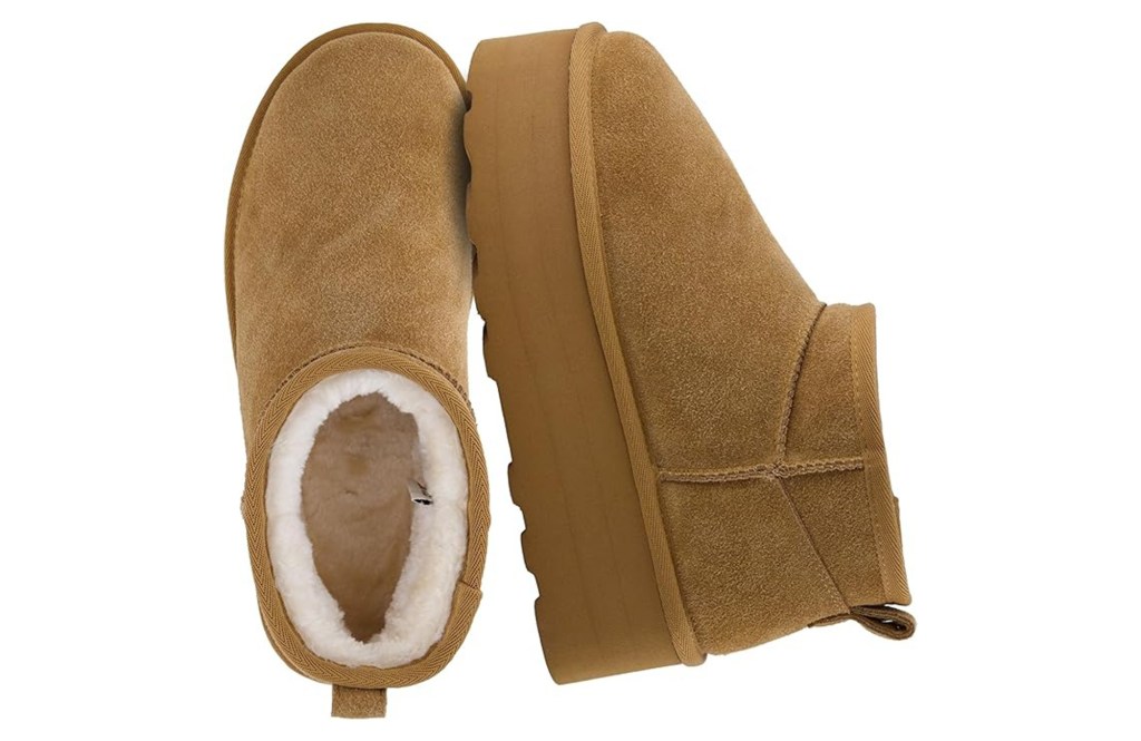 A pair of tan suede boots with white shearling lining.