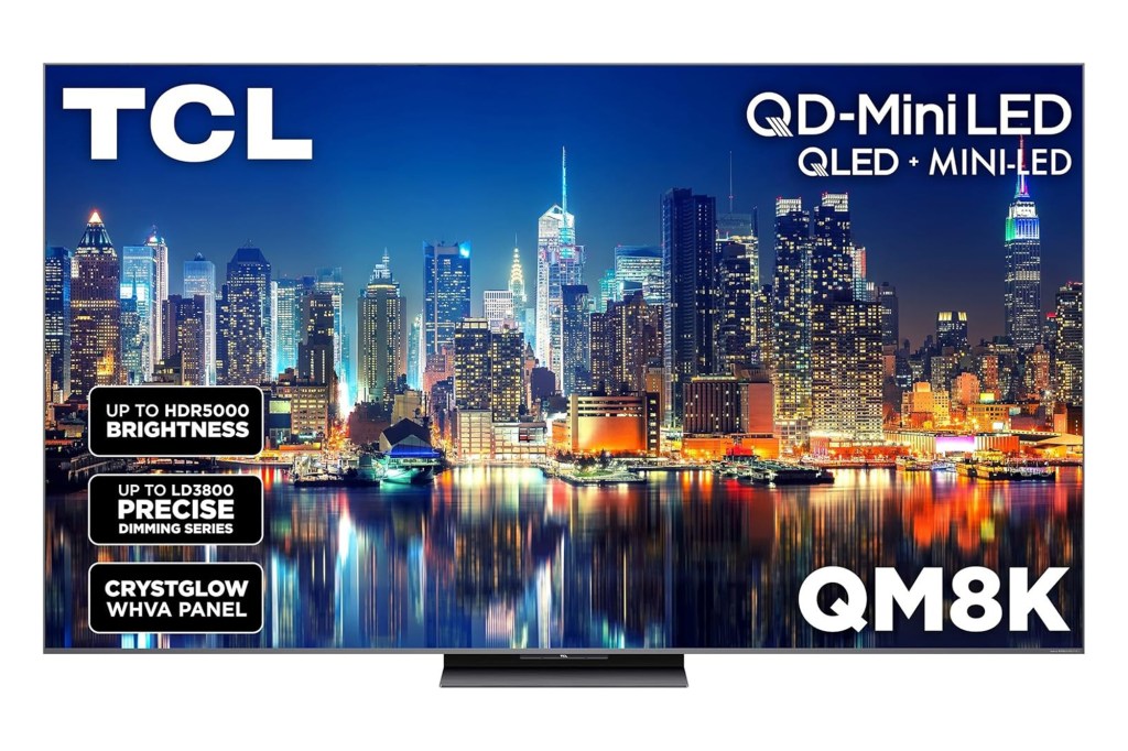 TCL QD-Mini LED QM8K TV displaying a city skyline at night with product features.