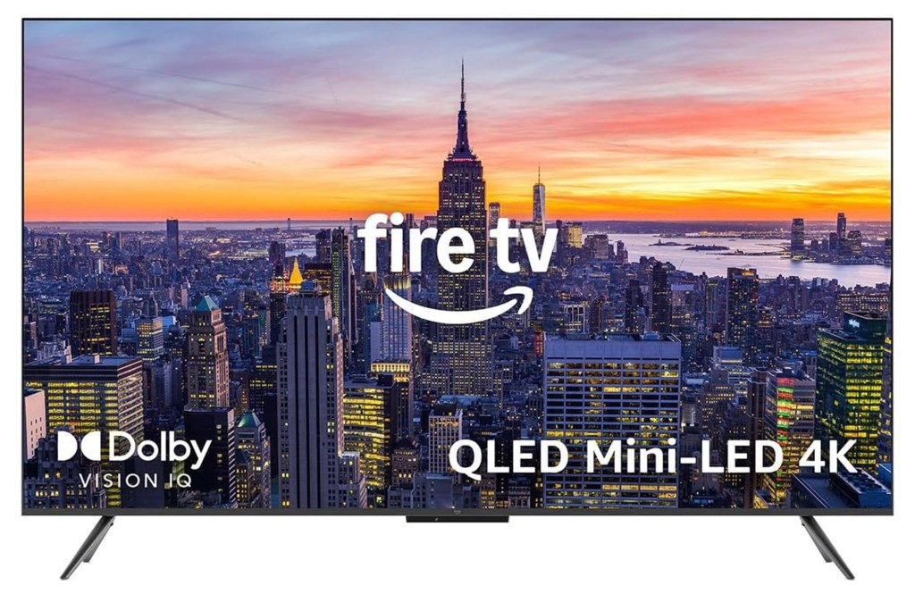 Television displaying a cityscape at sunset with "fire tv", "Dolby Vision IQ", and "QLED Mini-LED 4K" text.