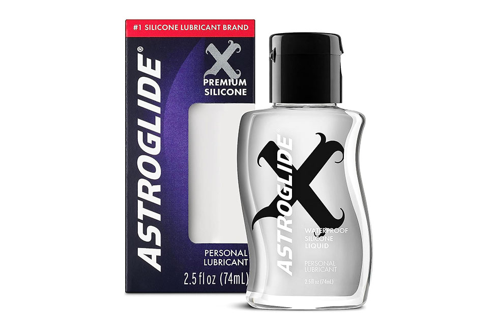 A bottle of liquid next to a box