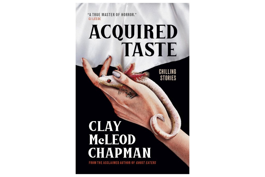 Acquired Taste book cover showing a pale hand holding an albino axolotl with red gills.