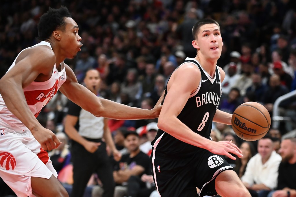 Nets' Egor Demin (8) drives past Toronto Raptors' Scottie Barnes, left, during second-half preseason NBA basketball game action in Toronto, Friday, Oct. 17, 2025.