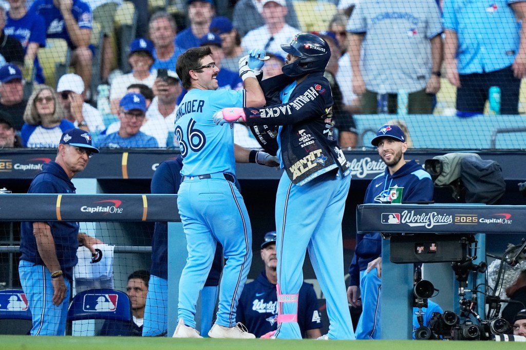 Toronto Blue Jays' Davis Schneider celebrates a home run against the Los Angeles Dodgers during the first inning in Game 5 of baseball's World Series, Wednesday, Oct. 29, 2025, in Los Angeles.