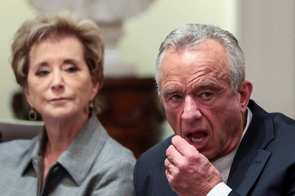 U.S. Health and Human Services (HHS) Secretary Robert F. Kennedy Jr. puts something in his mouth, as him and Education Secretary Linda McMahon attend a cabinet meeting at the White House, in Washington, D.C., U.S., October 9, 2025. 