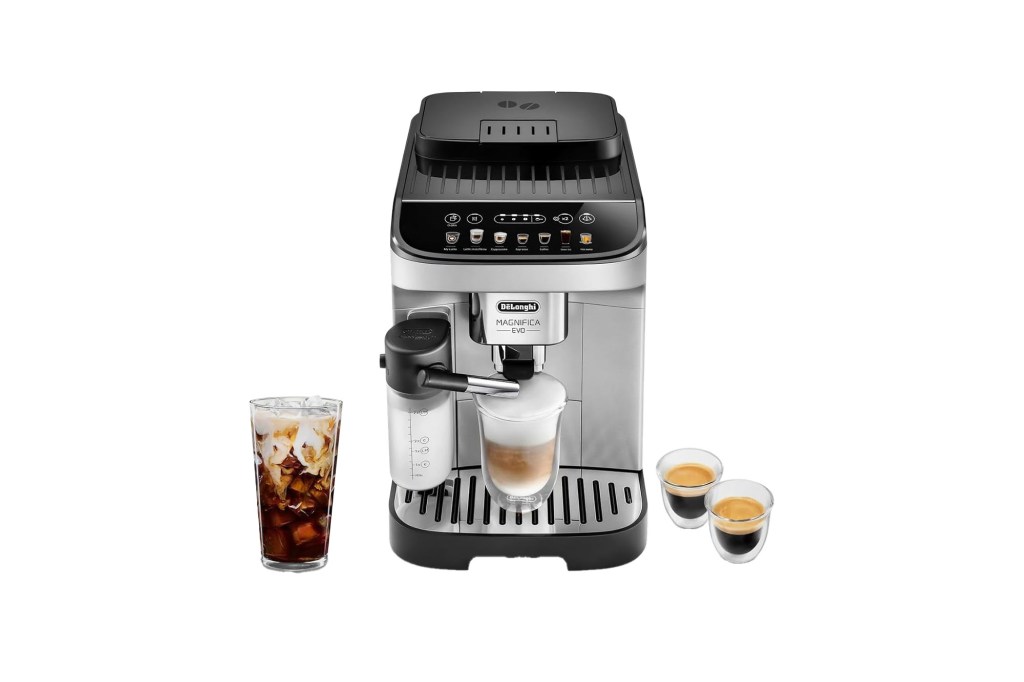 Delonghi Magnifica Evo coffee machine making a latte, with a glass of iced coffee and two espresso shots.