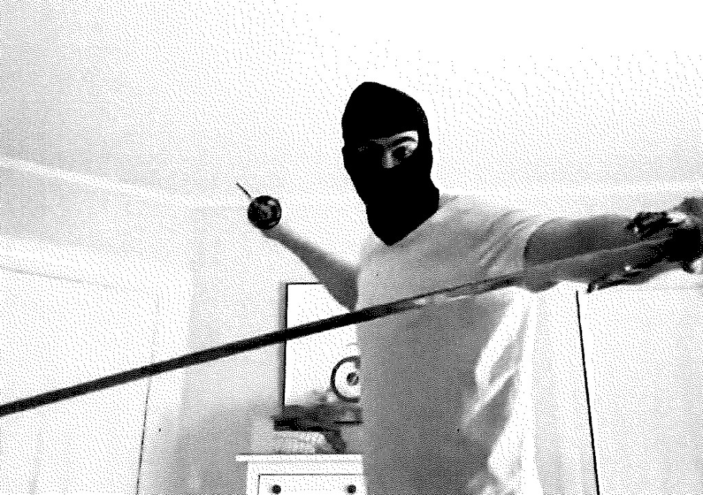 Milo Sedarat wearing a balaclava and holding a sword.