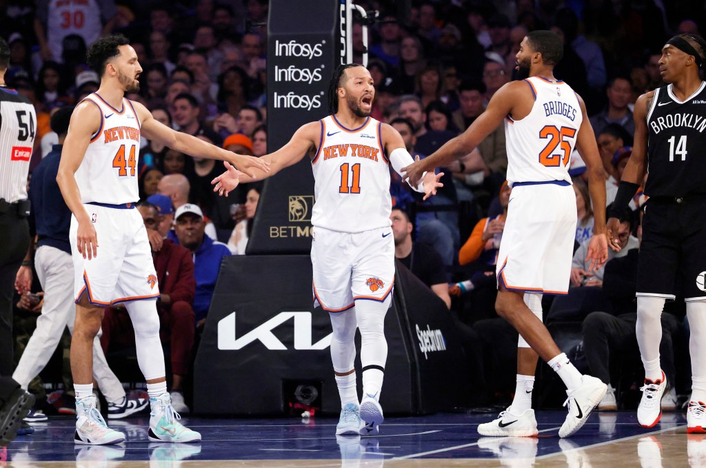 Jalen Brunson of the New York Knicks is greeted by Landry Shamet and Mikal Bridges after scoring.