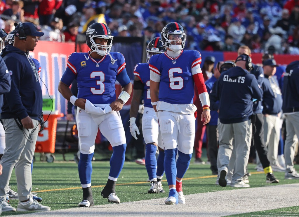 Russell Wilson #3 of the New York Giants and Jaxson Dart #6 of the New York Giants on the sideline.