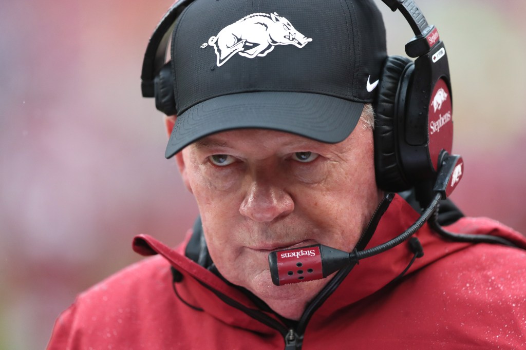 Arkansas Razorbacks interim head coach Bobby Petrino in a cap and headset.