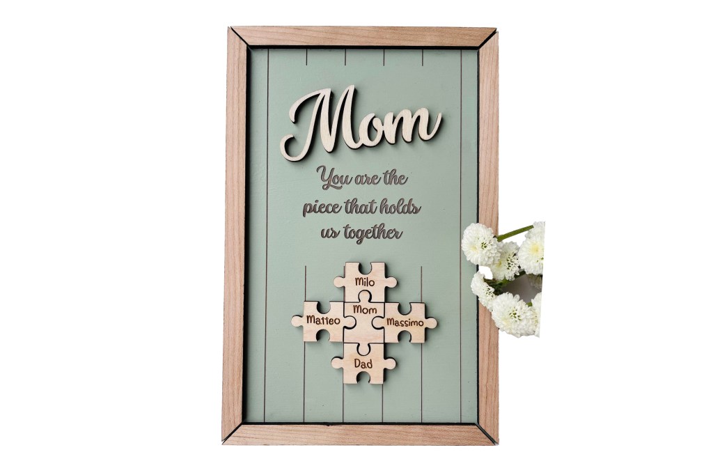 A frame featuring a puzzle piece and decorated with flowers